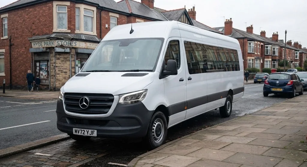 White Mercedes-Benz Sprinter minibus parked outside a corner shop on a residential street